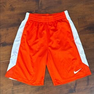Boys Orange and white Nike athletic shorts with side pockets